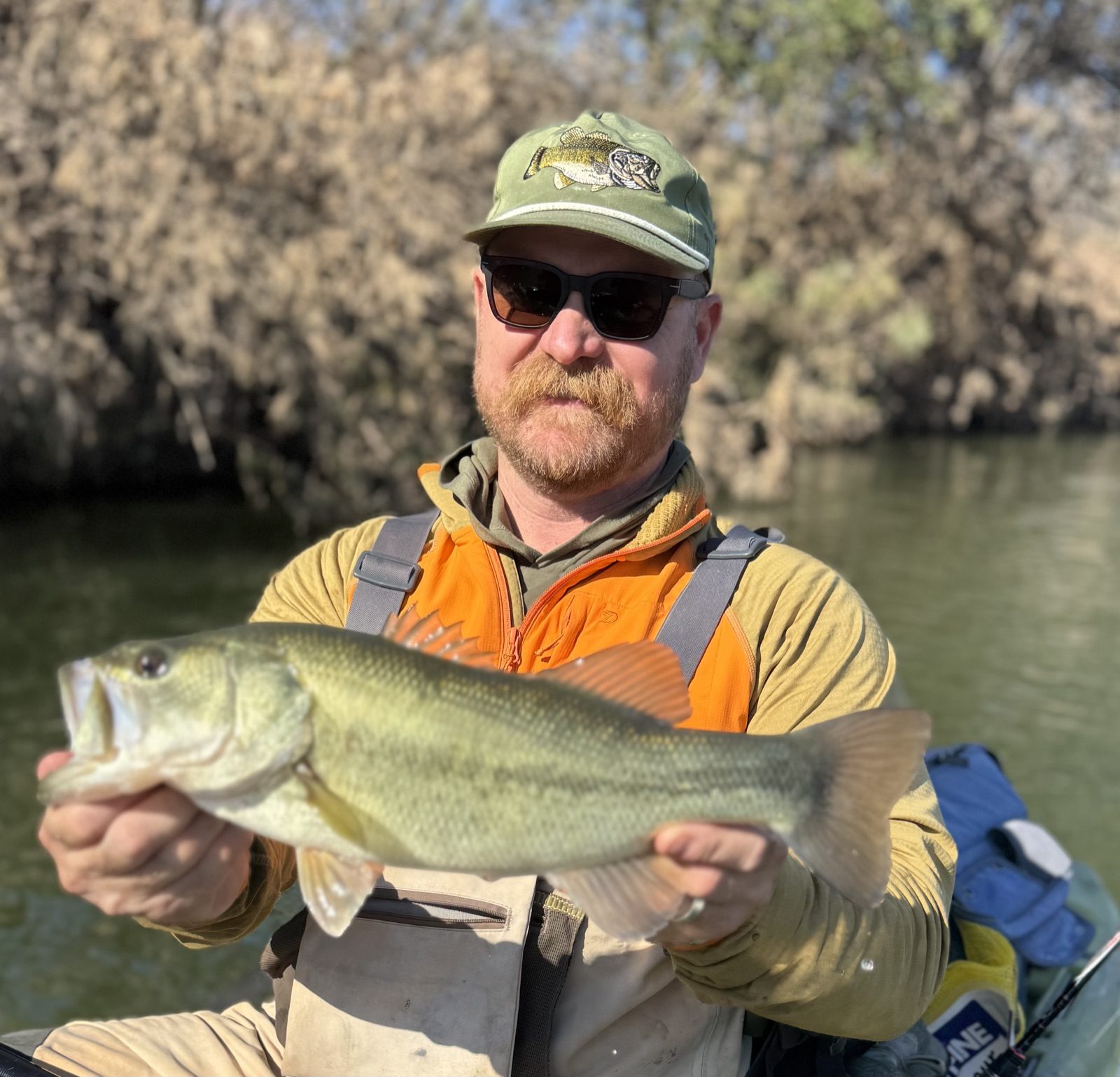 Jed Mazour holding a fish on the river