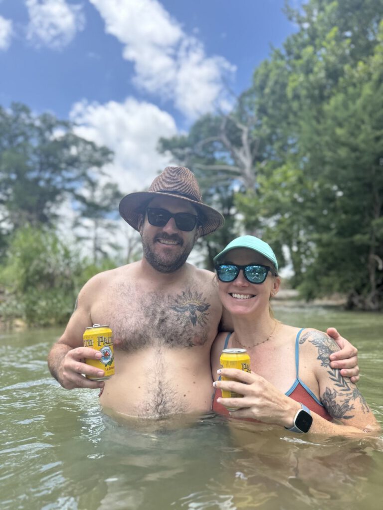 Smiling couple relaxing together during a sunny river outing