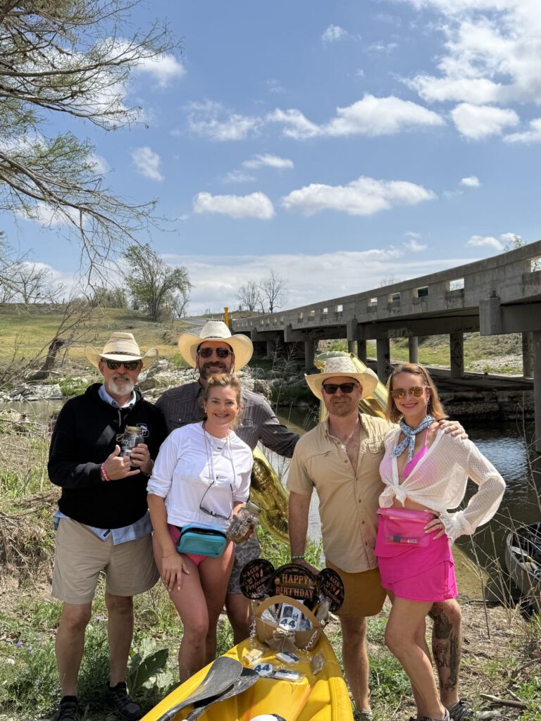 Group of friends gathered near a Hill Country river crossing